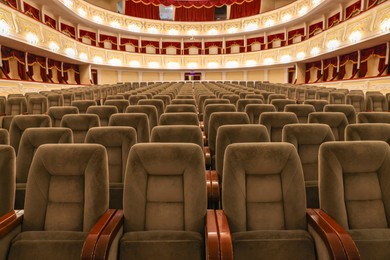 Photo of Rows of gray comfortable seats in theatre