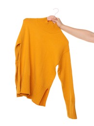 Photo of Woman holding hanger with bright sweater on white background, closeup