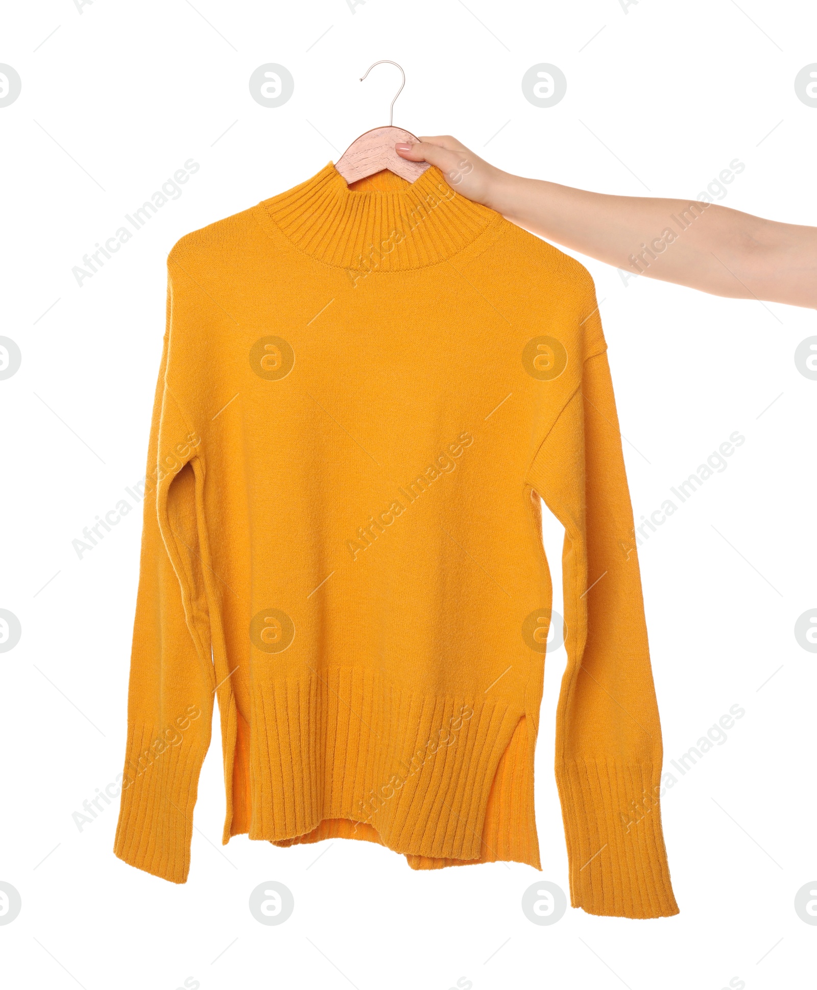 Photo of Woman holding hanger with bright sweater on white background, closeup