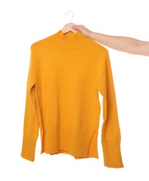 Photo of Woman holding hanger with bright sweater on white background, closeup