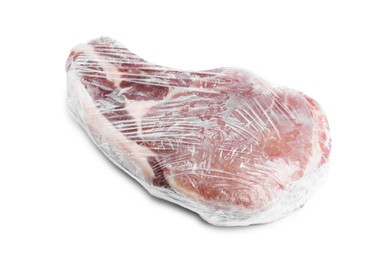 Photo of One frozen pork steak in plastic wrap isolated on white