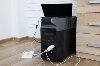 Modern portable power station, charging attached devices indoors