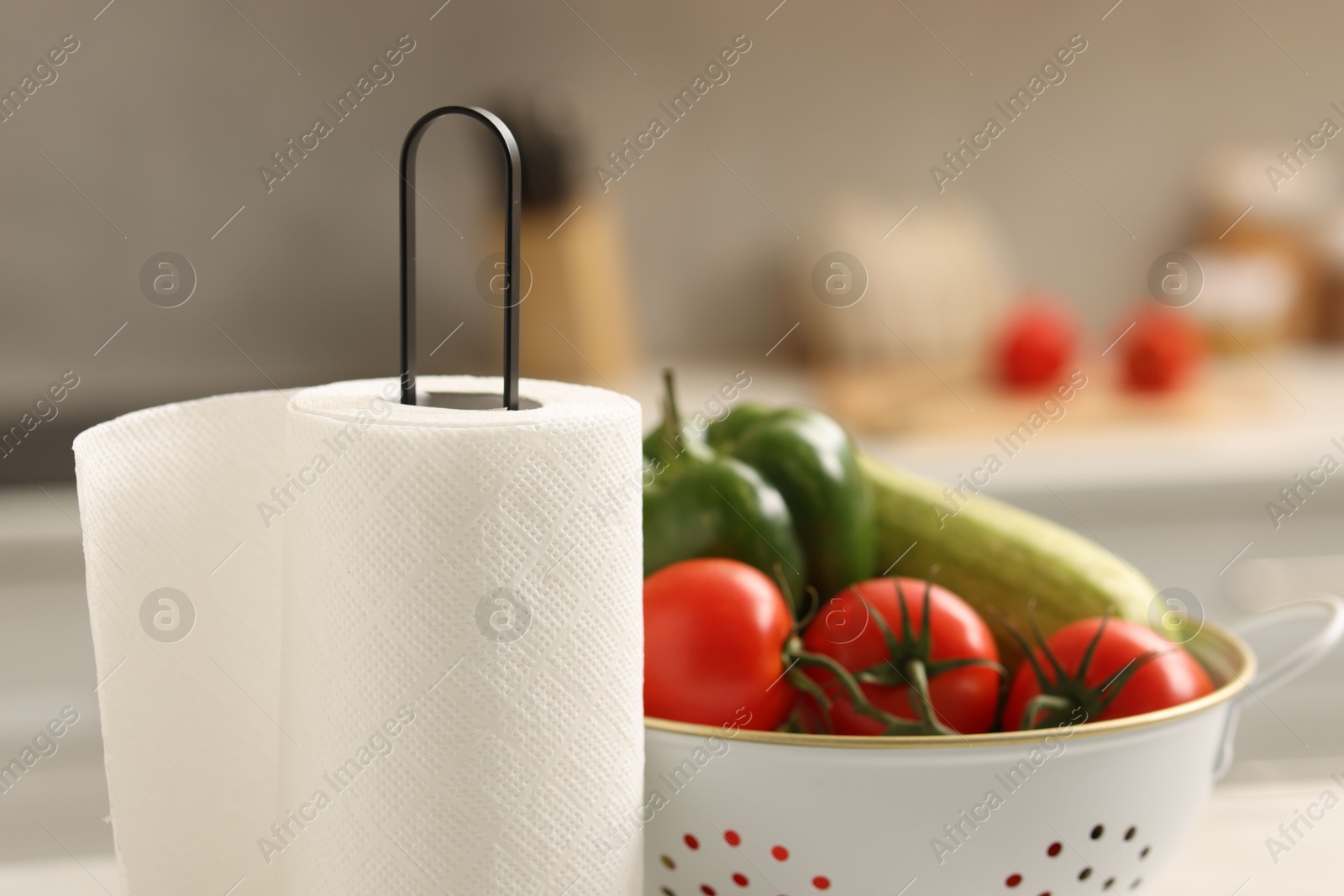 Photo of Roll of paper towels and vegetables in kitchen, closeup