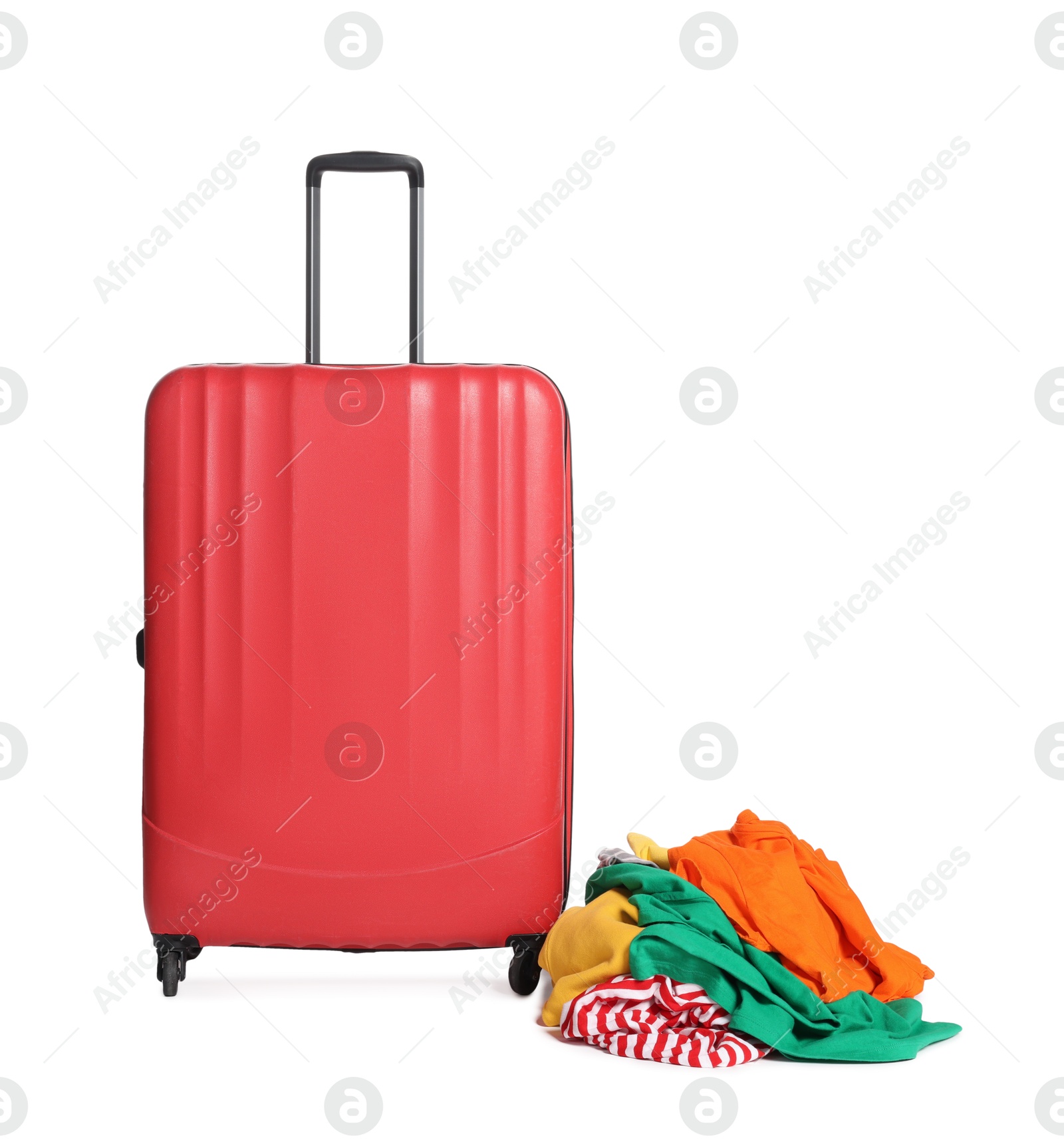 Red suitcase and messy pile of clothes isolated on white Photo of Red suitcase and messy pile of clothes isolated on white