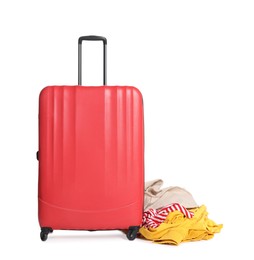 Photo of Red suitcase and messy pile of clothes isolated on white