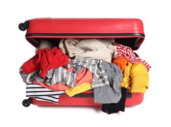 Photo of Packed suitcase full of clothes isolated on white