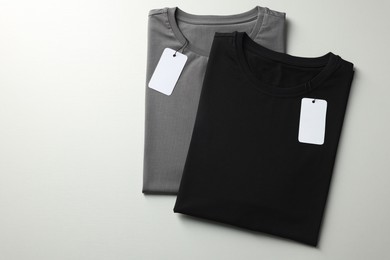 Photo of Different blank t-shirts on white background, top view. Mockup for design