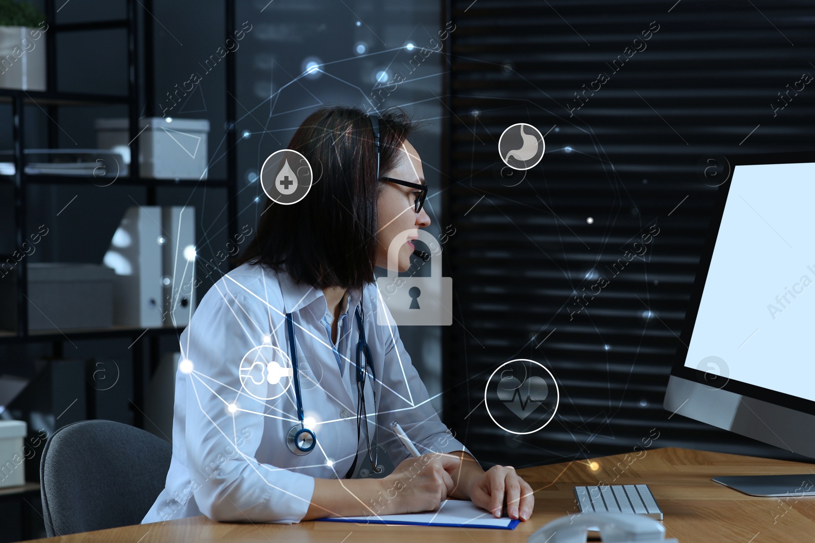 Image of Medical privacy. Doctor working at table and scheme with different icons