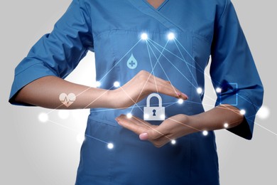 Image of Medical privacy. Health worker showing virtual lock icon and scheme, closeup