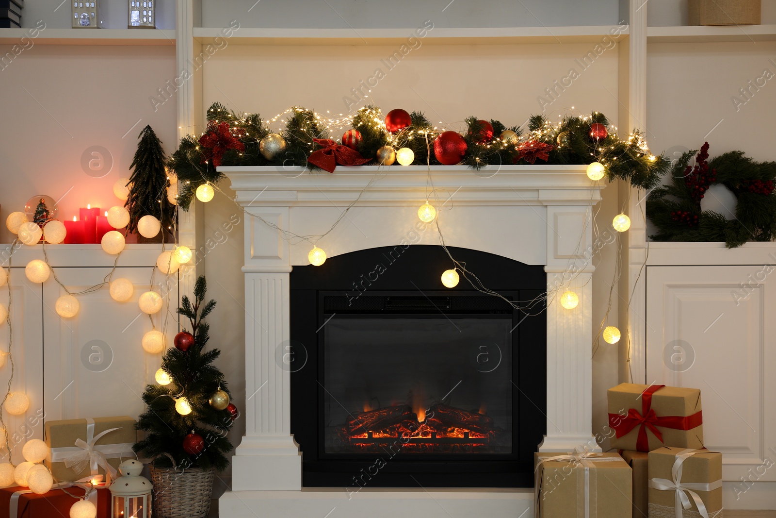 Photo of Stylish fireplace with Christmas decor and presents in cozy room