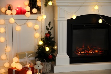 Photo of Stylish fireplace with Christmas decor and presents in cozy room