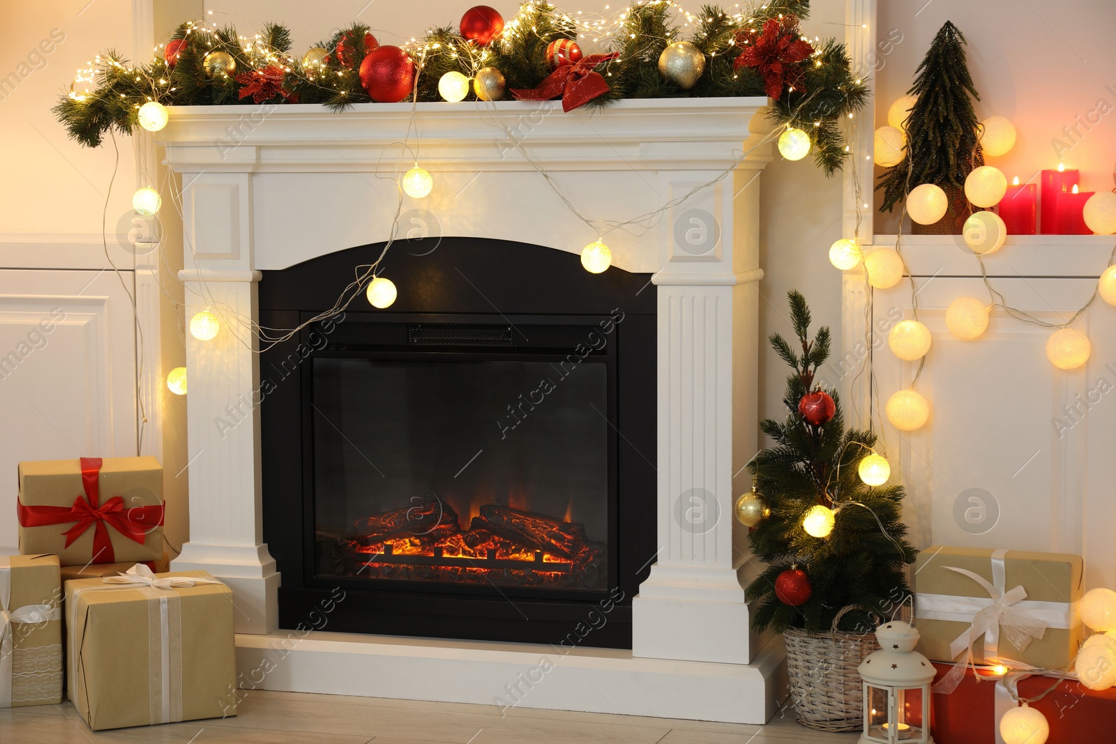 Photo of Stylish fireplace with Christmas decor and presents in cozy room