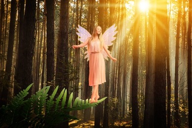 Image of Charming fairy standing on fern leaf under sunlight among trees. Mesmerizing girl with ethereal wings in forest