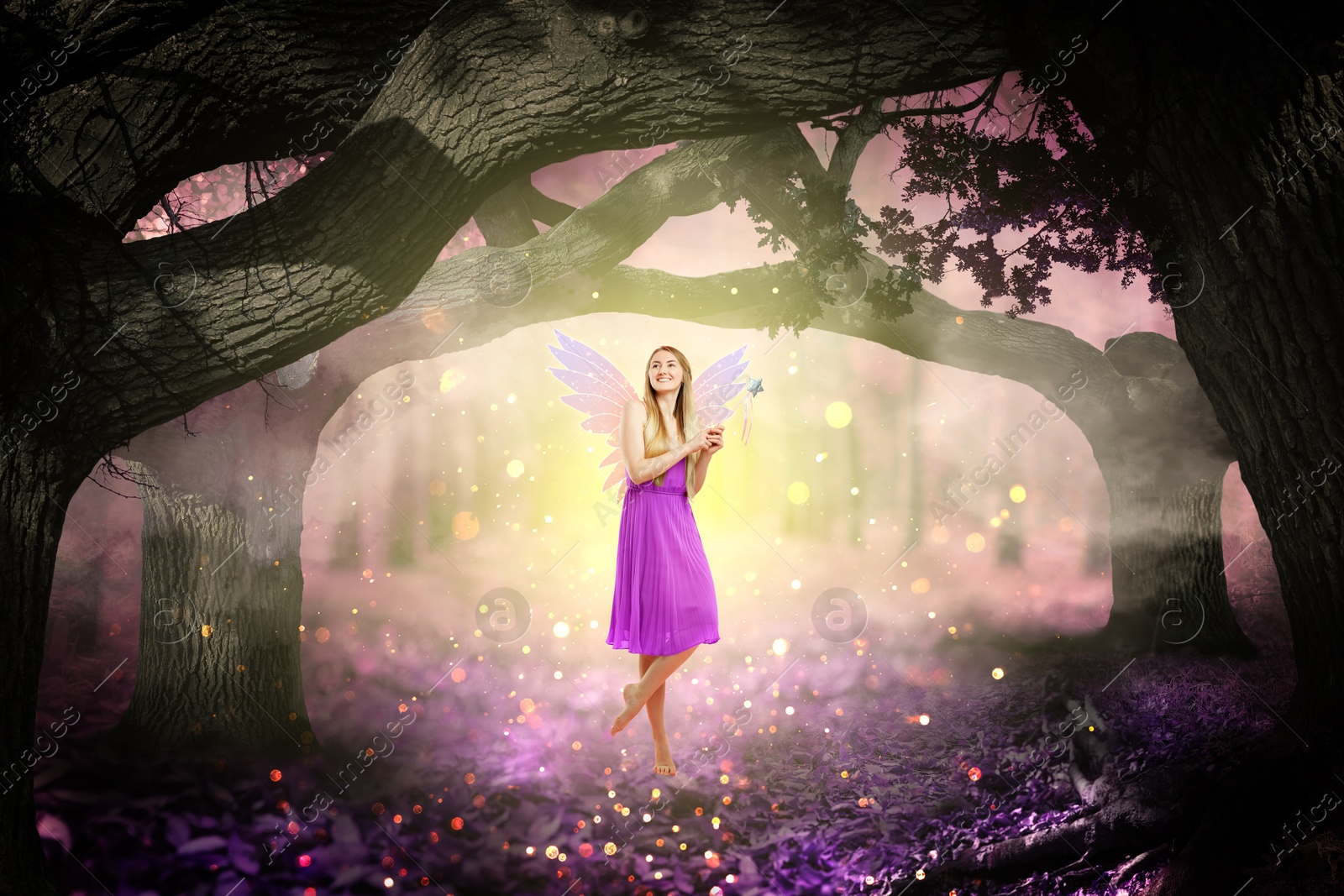 Image of Enchanting fairy with magic wand among trees. Mesmerizing girl with ethereal wings in charmed forest