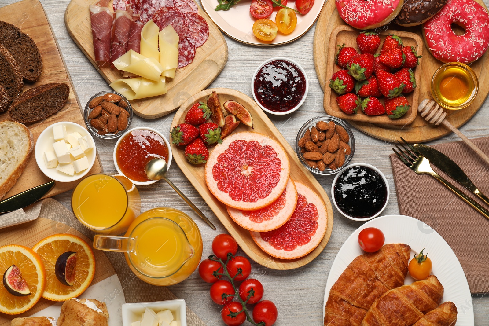 Photo of Different tasty food served for brunch on wooden table, flat lay