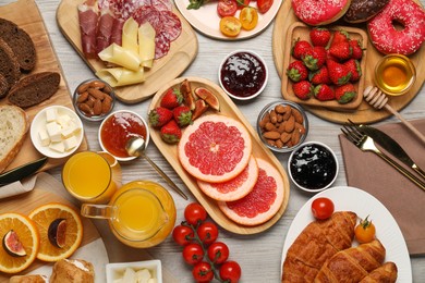 Photo of Different tasty food served for brunch on wooden table, flat lay