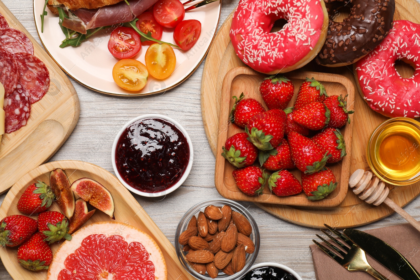 Photo of Different tasty food served for brunch on wooden table, flat lay