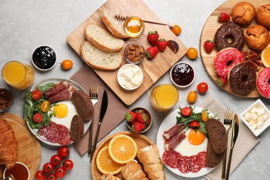 Photo of Different tasty food served for brunch on grey marble table, flat lay