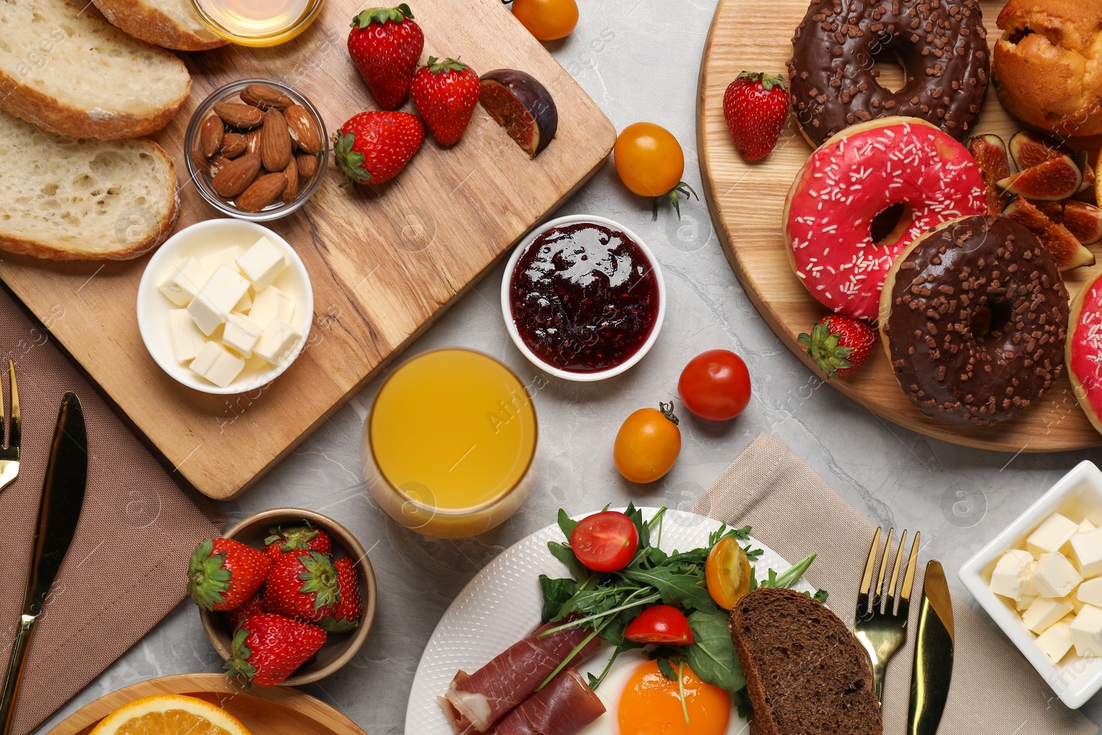 Photo of Different tasty food served for brunch on grey marble table, flat lay