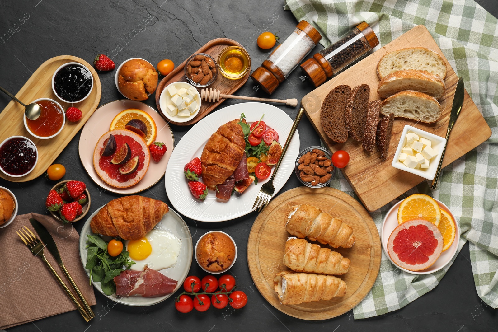 Photo of Different tasty food served for brunch on grey textured table, flat lay