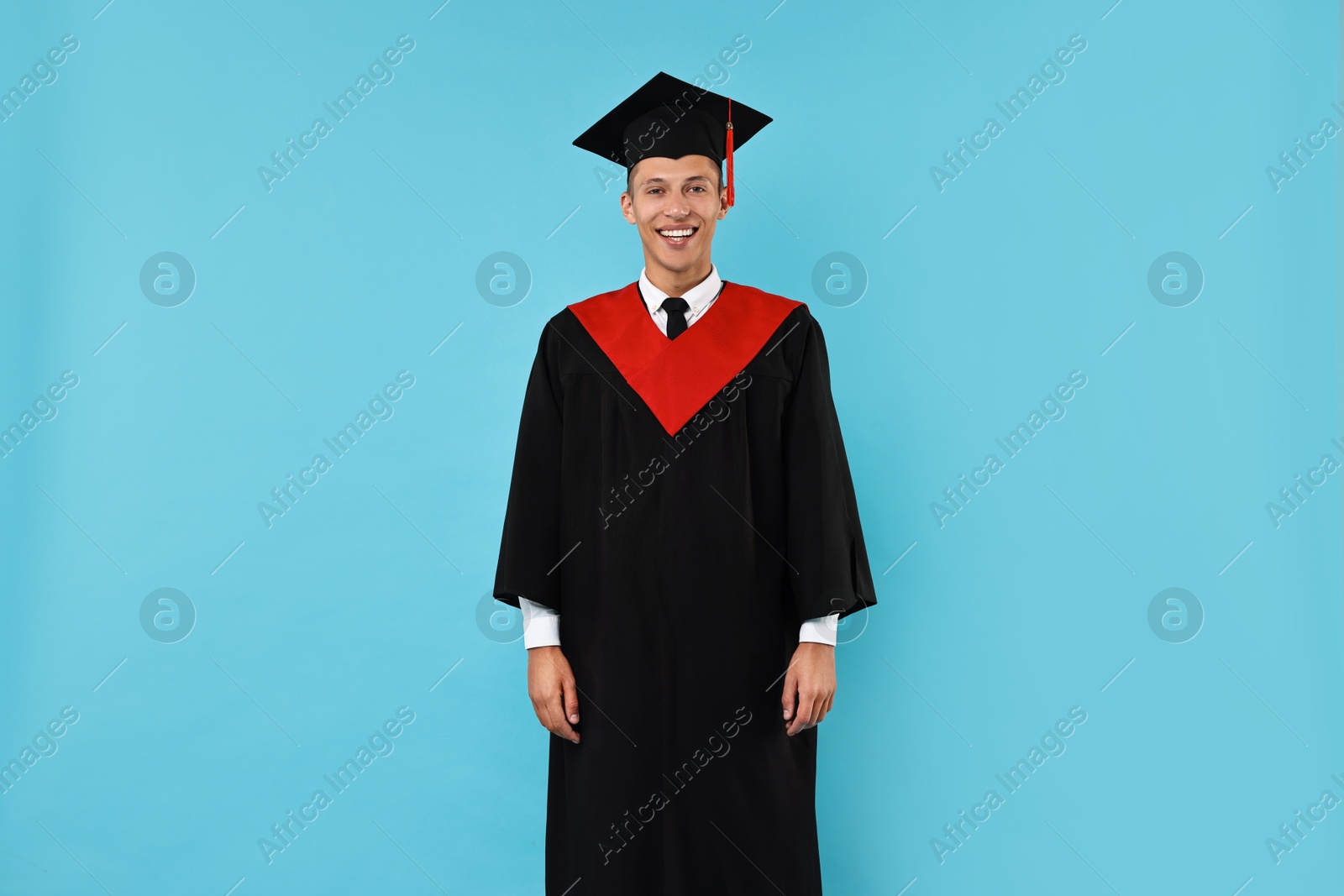 Photo of Happy student after graduation on light blue background