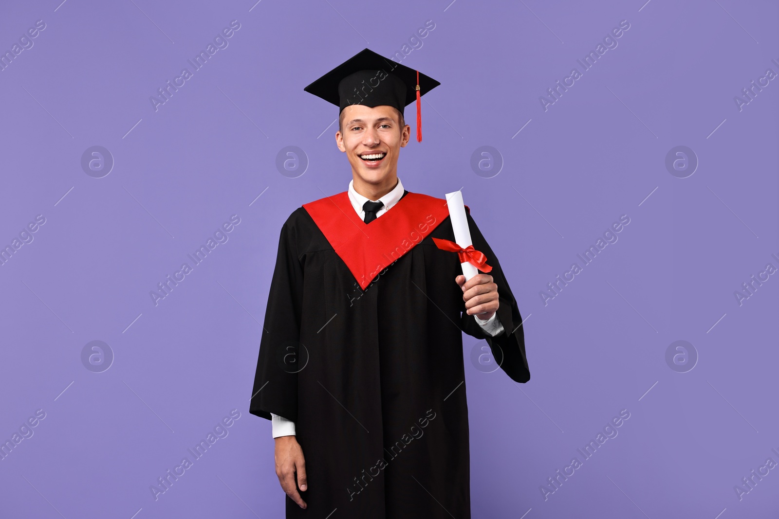 Photo of Happy student with diploma after graduation on violet background