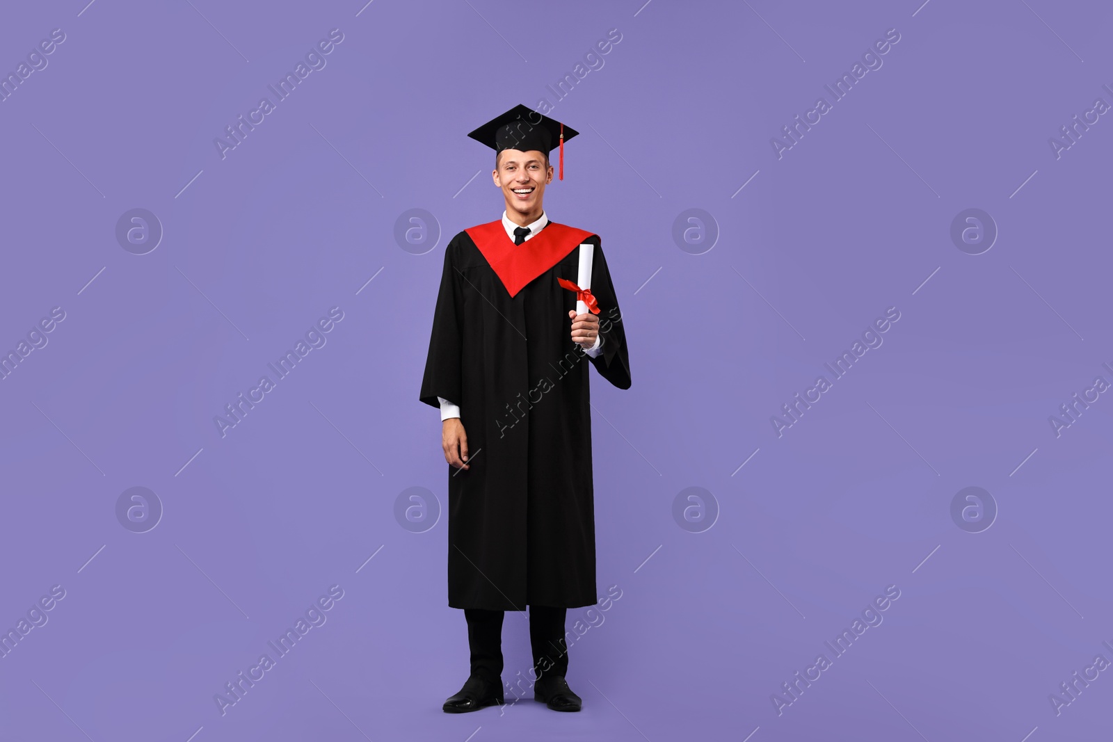 Photo of Happy student with diploma after graduation on violet background