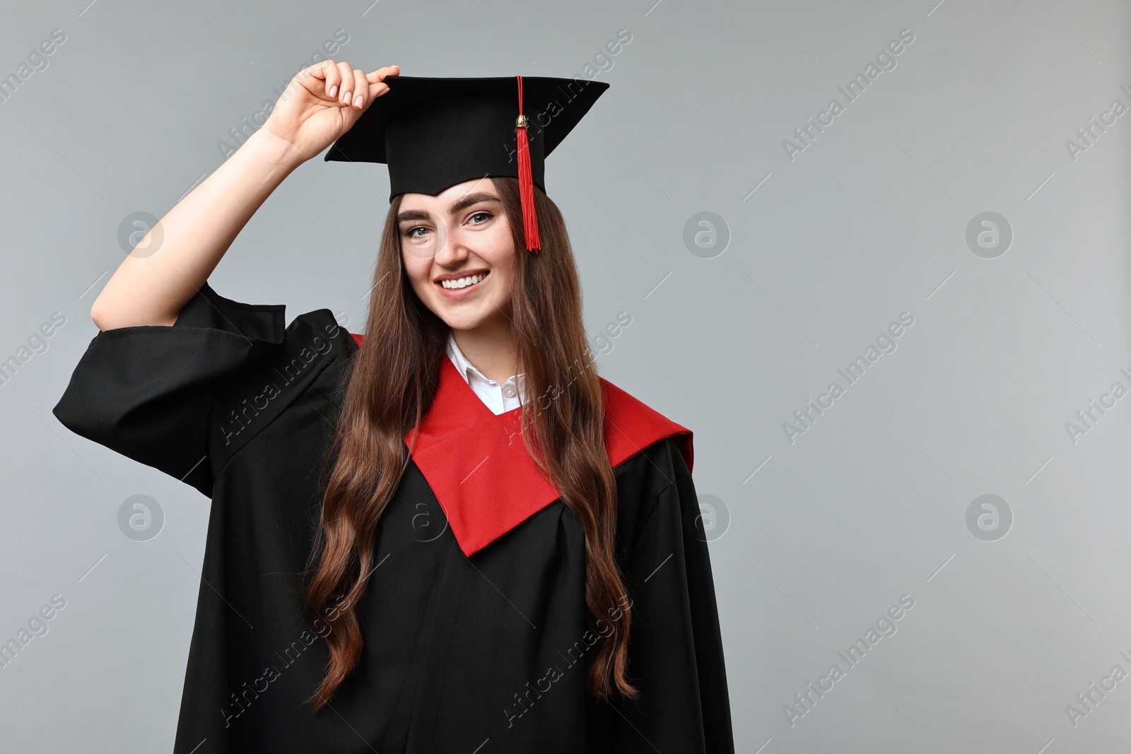 Photo of Happy student after graduation on grey background. Space for text