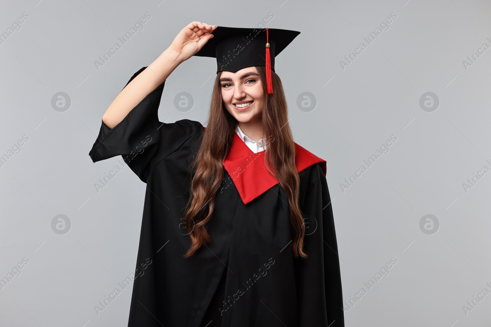 Photo of Happy student after graduation on grey background