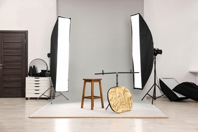 Photo of Professional lighting equipment setup in modern photo studio