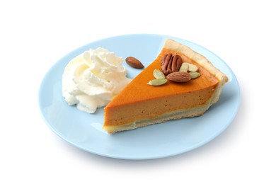 Photo of Piece of tasty homemade pumpkin pie with whipped cream, seeds and nuts isolated on white