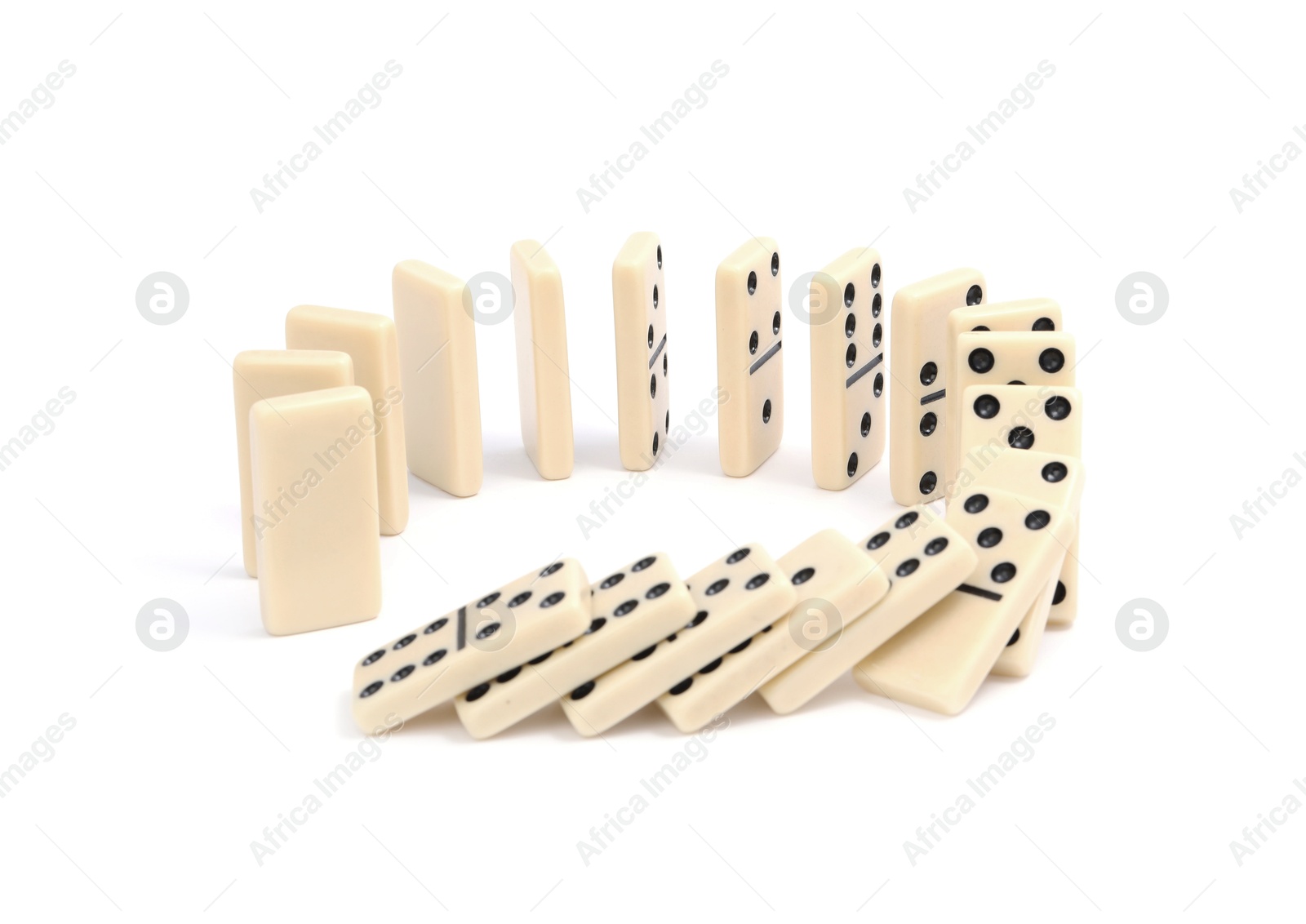 Photo of Domino effect. Tiles falling on white background