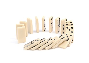 Photo of Domino effect. Tiles falling on white background