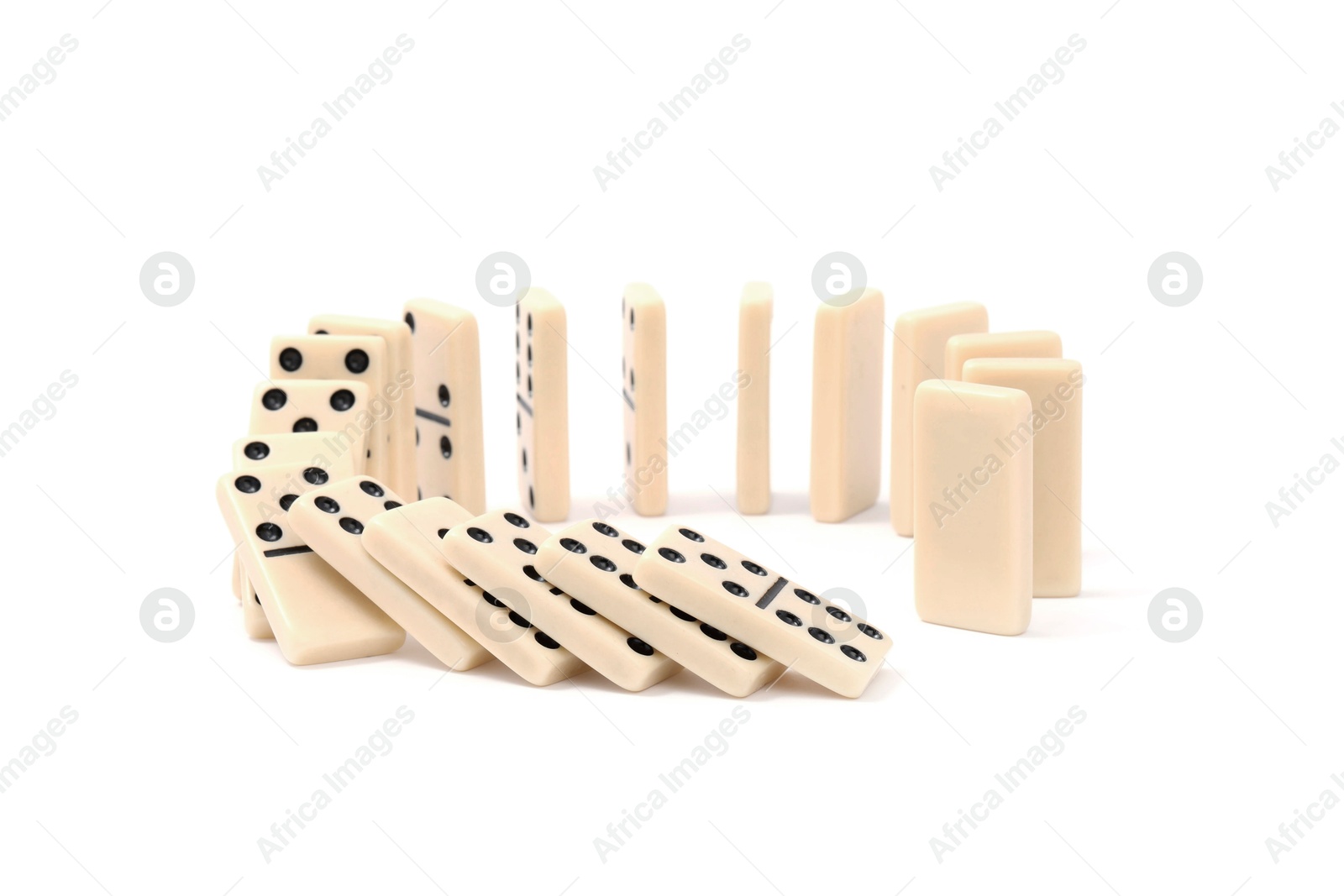 Photo of Domino effect. Tiles falling on white background