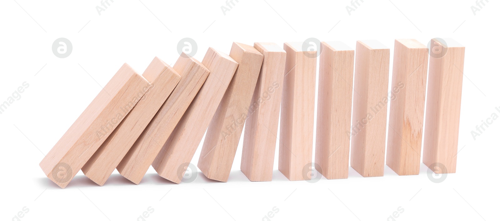 Photo of Domino effect. Wooden blocks falling on white background