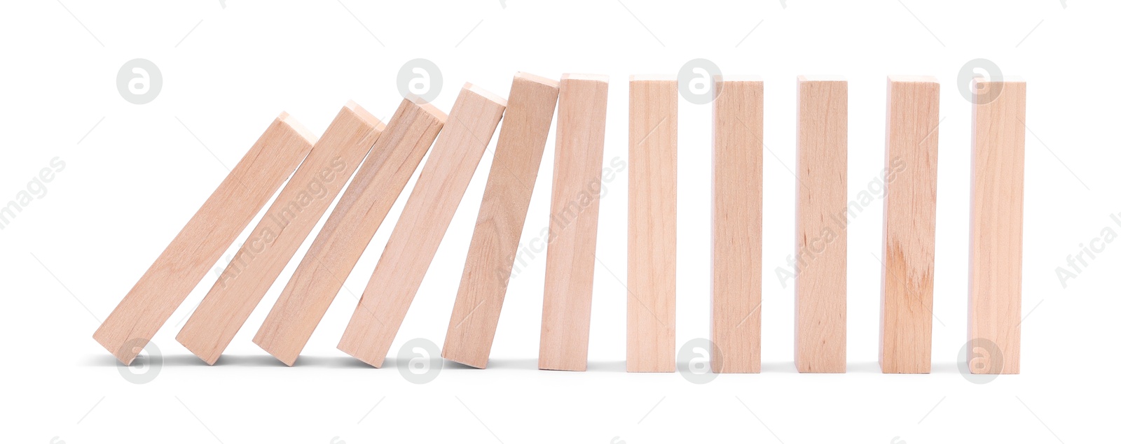 Photo of Domino effect. Wooden blocks falling on white background