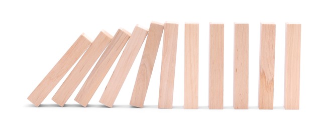 Photo of Domino effect. Wooden blocks falling on white background