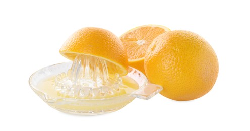 Photo of Glass juicer and oranges isolated on white