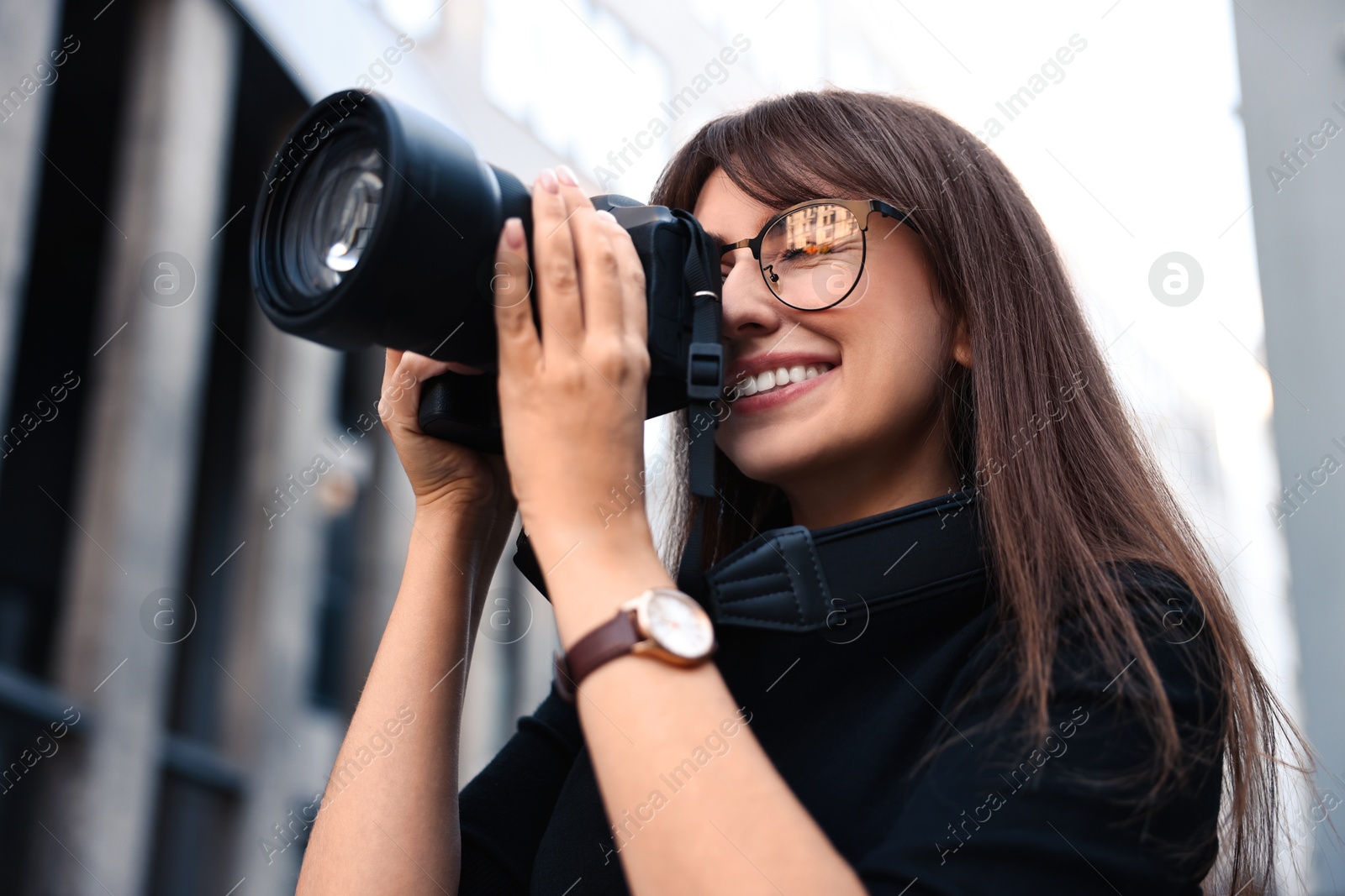 Photo of Professional photographer taking picture with camera outdoors