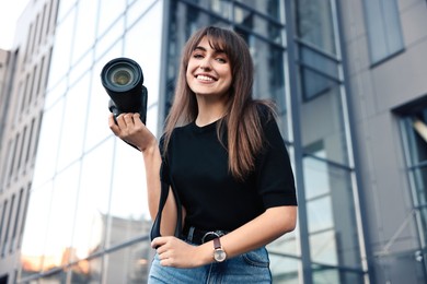 Professional photographer with digital camera near building outdoors