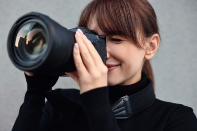 Photo of Professional photographer taking picture with camera outdoors