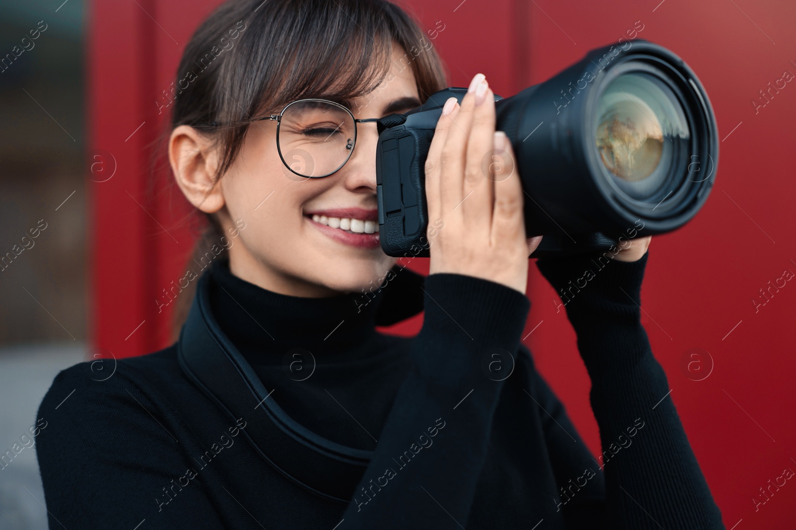 Photo of Professional photographer taking picture with camera outdoors