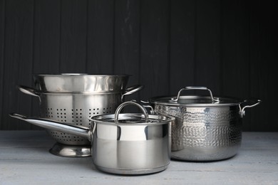 Stainless steel dishware on grey wooden table