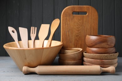 Photo of Dishware and cooking utensils on grey wooden table