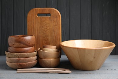 Photo of Dishware and cooking utensils on grey wooden table