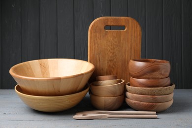 Photo of Dishware and cooking utensils on grey wooden table