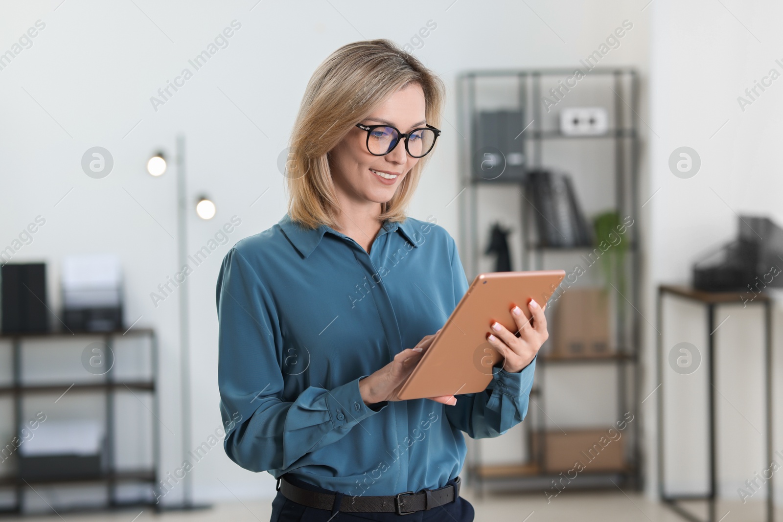 Photo of Portrait of businesswoman using tablet in office