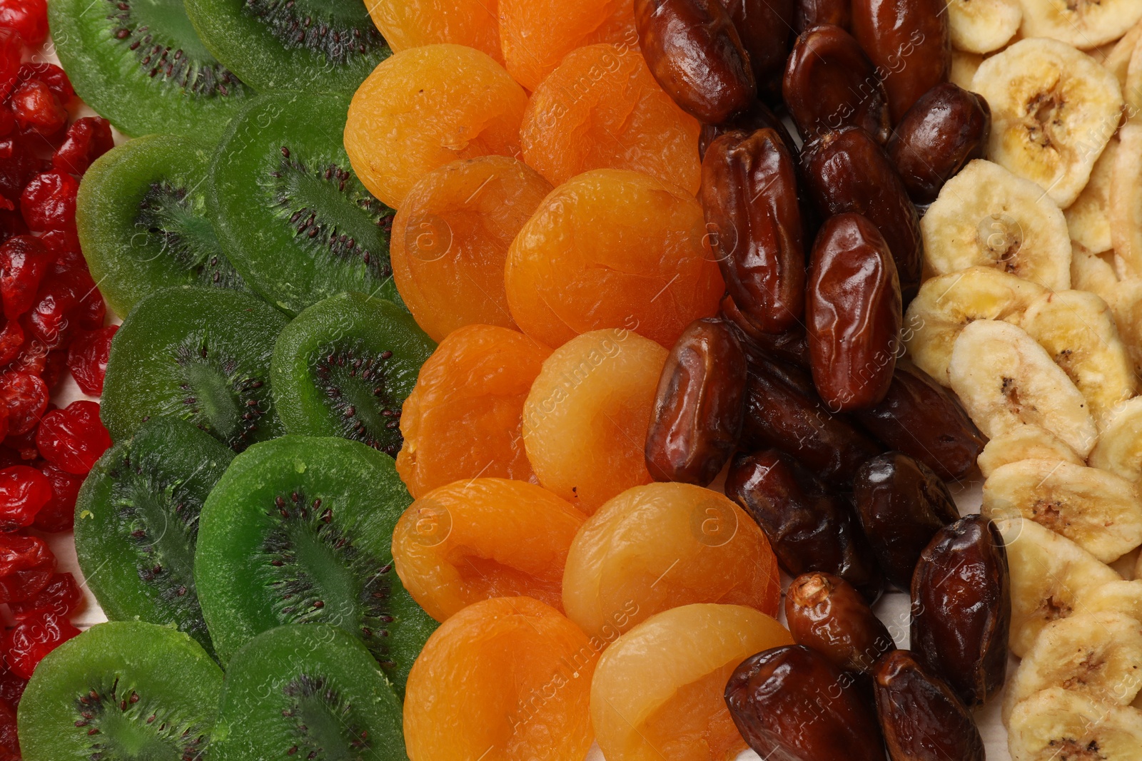 Photo of Mix of different dried fruits on table, top view