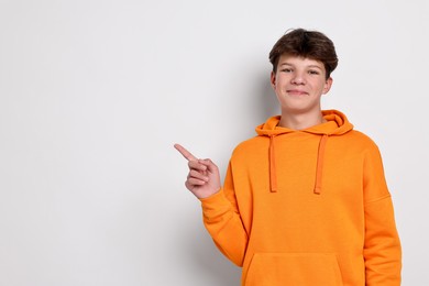 Portrait of teenage boy on white background, space for text