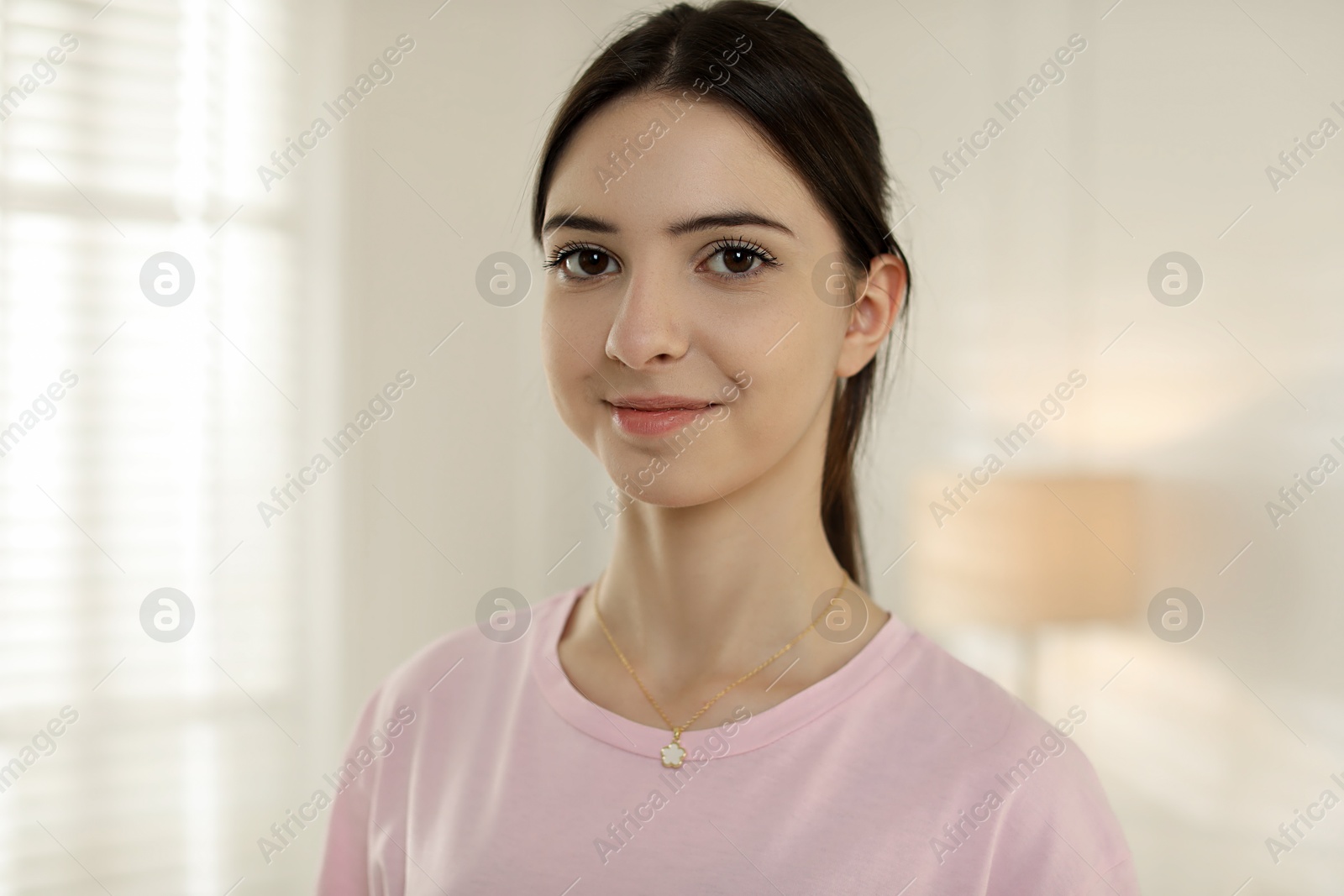 Photo of Portrait of beautiful teenage girl at home